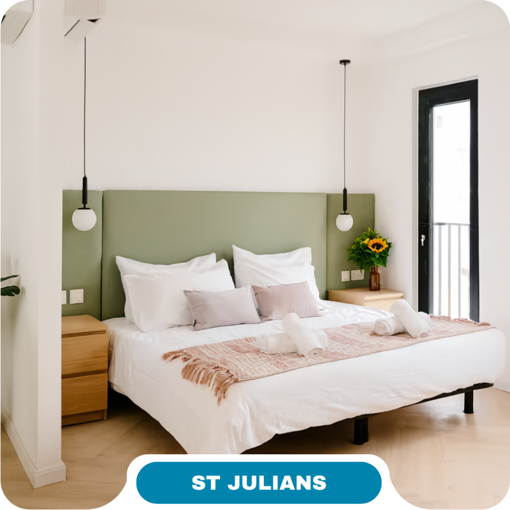 Bright, modern bedroom perfect for short term rentals, featuring a green headboard, double bed, white linens, bedside tables, pendant lights, sunflowers, and a large window. Text at bottom reads "ST JULIANS".